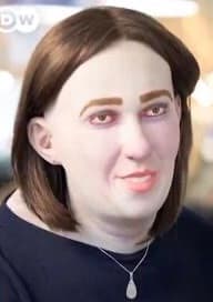 Image of what I believe was supposed to be an office worker as an office worker would look after many years of sitting at a desk experience little sunlight and physical activity. It is not a real human face, very pale, looks both vaguely androgenous, and also vaguely like Nic Cage. The eyes are ringed in dark baggy skin; the face is bloated. The smile is dead. This figure, and what it portened, really frightened me at the time, and still does!